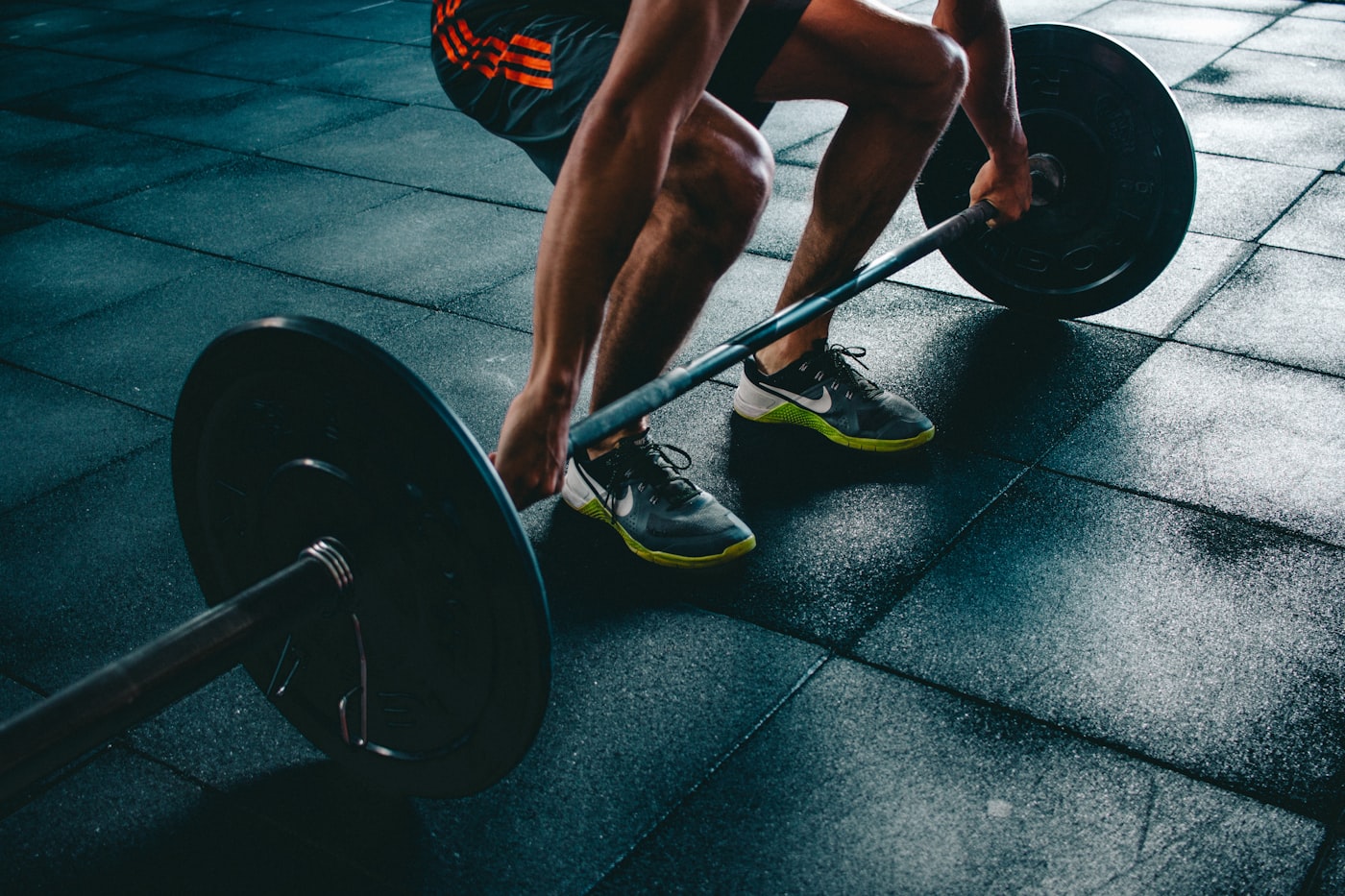 Barbell and plates on a gym floor